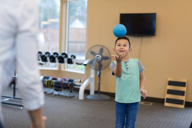 istock A young boy does throwing exercises in a physical therapy clinic 1155537758