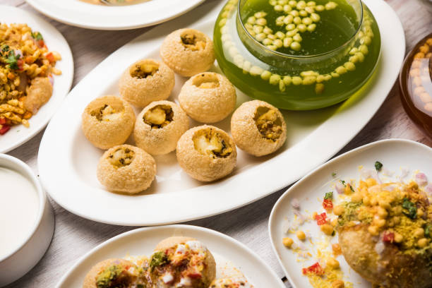 Bombay Chat food in group group of Bombay chat food includes golgappa/panipuri, bhel-puri, sev-poori, dahipuri, Ragda pattice, raj kachori etc. selective focus raj kachori stock pictures, royalty-free photos & images
