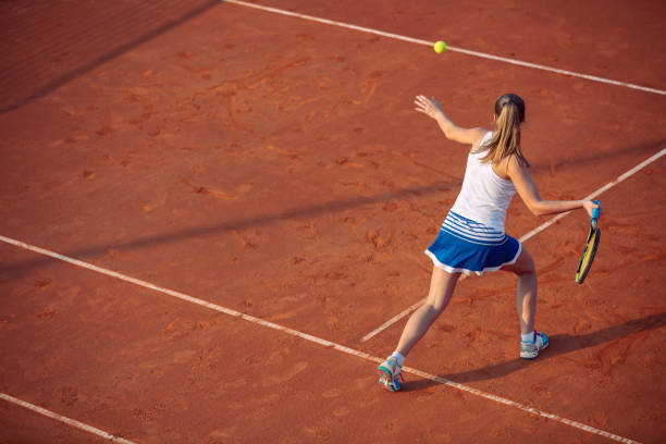 istock Young woman playing tennis on clay. Forehand. 1155539162