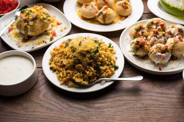 Bombay Chat food in group group of Bombay chat food includes golgappa/panipuri, bhel-puri, sev-poori, dahipuri, Ragda pattice, raj kachori etc. selective focus raj kachori stock pictures, royalty-free photos & images