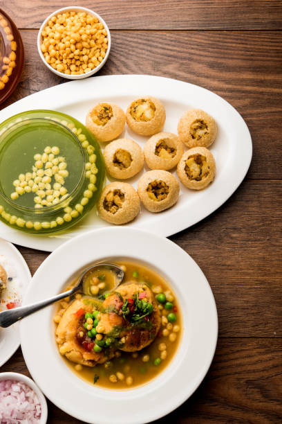 Bombay Chat food in group group of Bombay chat food includes golgappa/panipuri, bhel-puri, sev-poori, dahipuri, Ragda pattice, raj kachori etc. selective focus raj kachori stock pictures, royalty-free photos & images