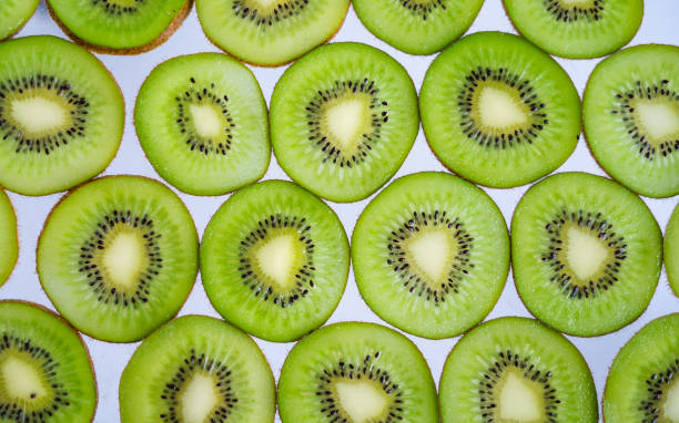 istock Kiwi Fruits On White wood Background 1155548759