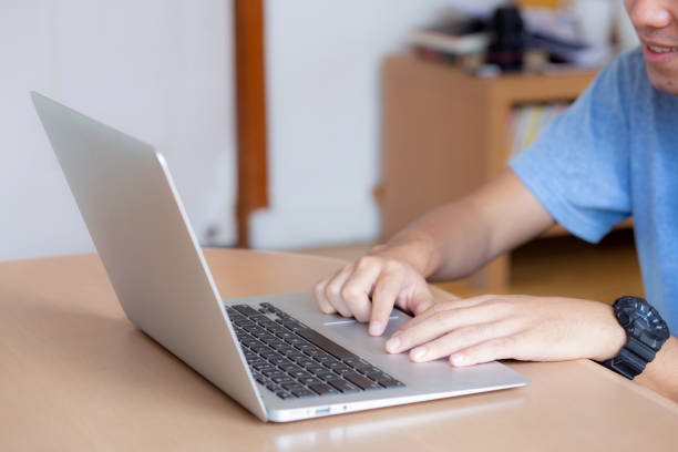 istock Closeup freelance asian man working and typing on laptop computer at desk office with professional, businessman using notebook checking email or social network, business and lifestyle concept. 1155556147