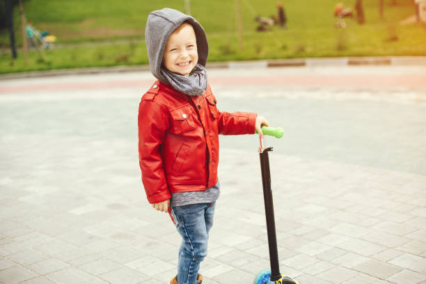 istock Cute child in a park playing on a grass 1155558552