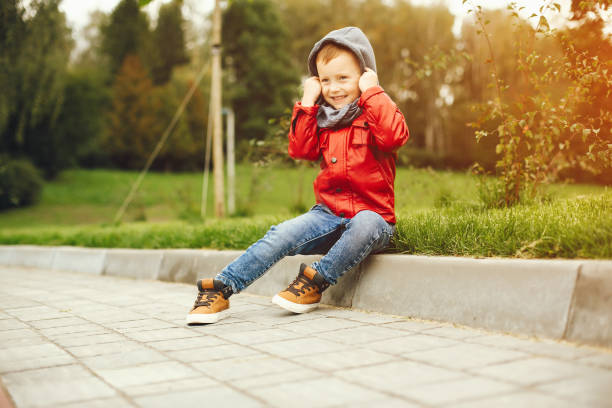 istock Cute child in a park playing on a grass 1155558691