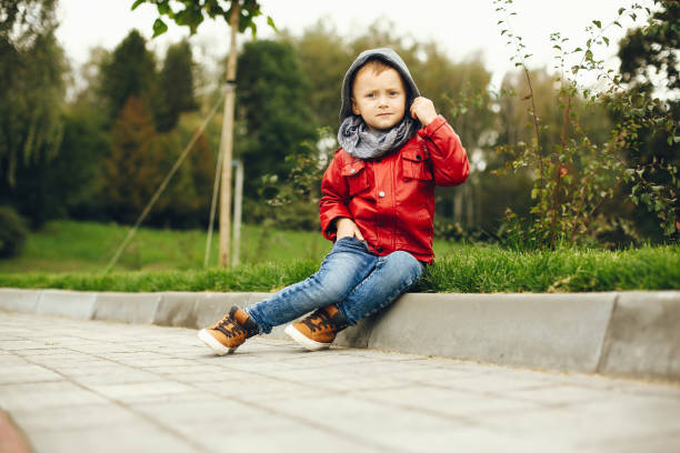 istock Cute child in a park playing on a grass 1155558703