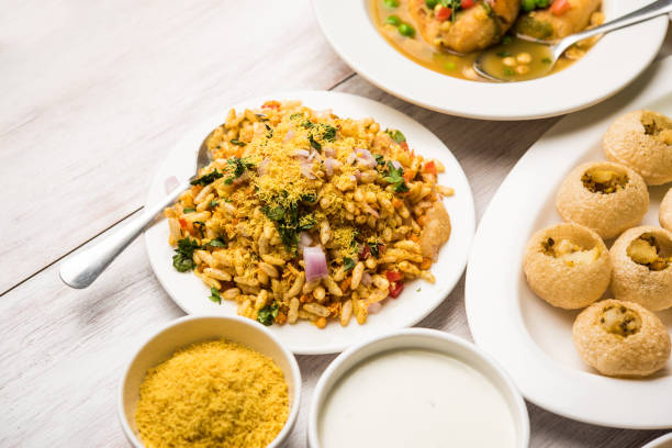 Bombay Chat food in group group of Bombay chat food includes golgappa/panipuri, bhel-puri, sev-poori, dahipuri, Ragda pattice, raj kachori etc. selective focus raj kachori stock pictures, royalty-free photos & images
