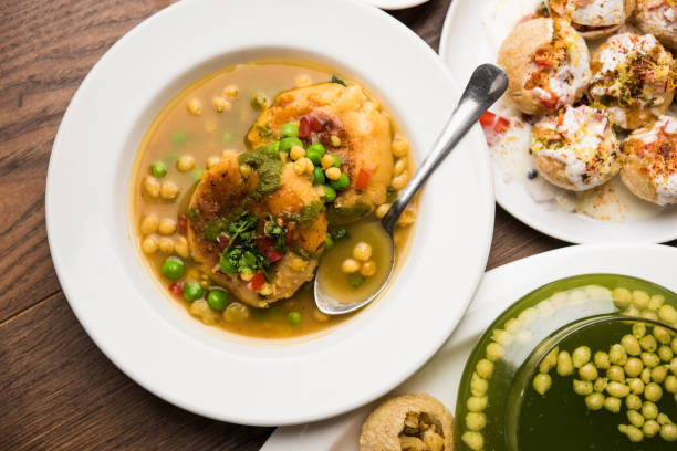 Bombay Chat food in group group of Bombay chat food includes golgappa/panipuri, bhel-puri, sev-poori, dahipuri, Ragda pattice, raj kachori etc. selective focus raj kachori stock pictures, royalty-free photos & images