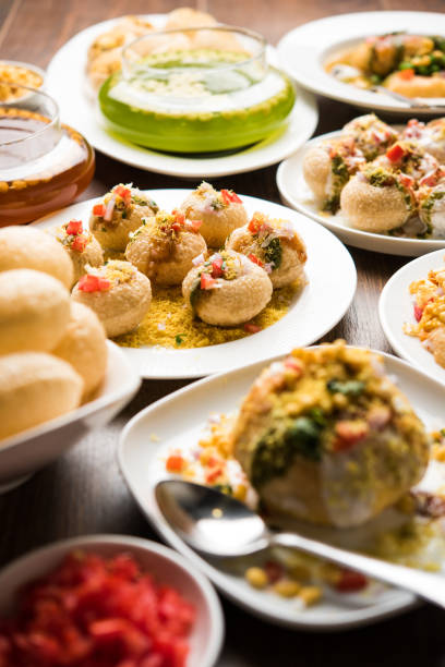 Bombay Chat food in group group of Bombay chat food includes golgappa/panipuri, bhel-puri, sev-poori, dahipuri, Ragda pattice, raj kachori etc. selective focus raj kachori stock pictures, royalty-free photos & images
