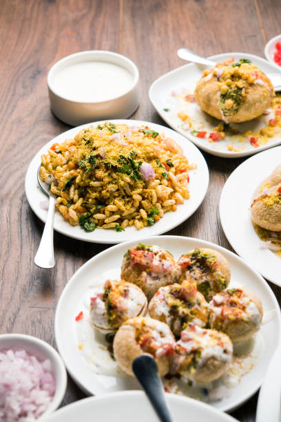Bombay Chat food in group group of Bombay chat food includes golgappa/panipuri, bhel-puri, sev-poori, dahipuri, Ragda pattice, raj kachori etc. selective focus raj kachori stock pictures, royalty-free photos & images