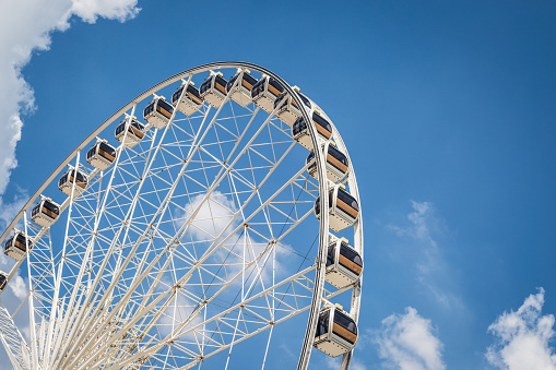 White Beautiful large Ferris wheel with blue sky background