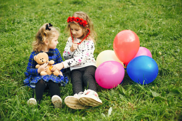 istock Cute child in a park playing on a grass 1155559745