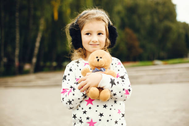 istock Cute child in a park playing on a grass 1155560023