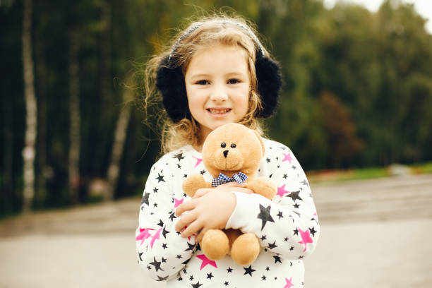 istock Cute child in a park playing on a grass 1155560030