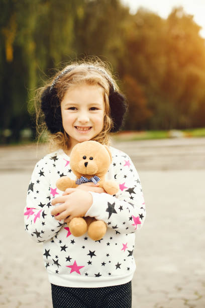 istock Cute child in a park playing on a grass 1155560032