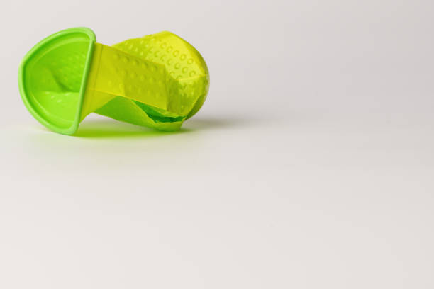 istock Green disposable plastic Cup broken lies on white background. Isolated background. 1155562088