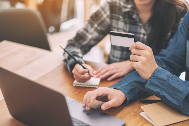 istock Businessman using credit card for shopping online 1155563748