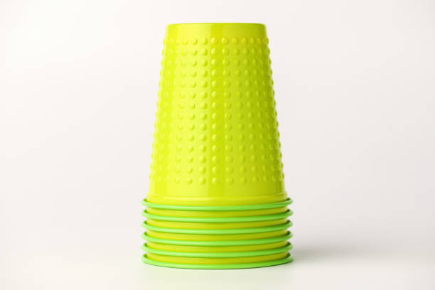 istock A group of green plastic cups lie upside down on a white background. The cups are a doll. 1155563821