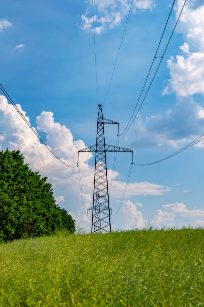 istock High-voltage power line against the blue sky with clouds 1155564918