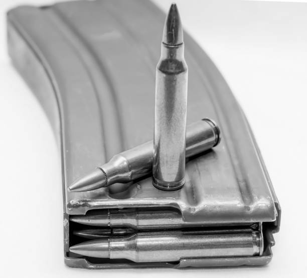 istock 223 caliber bullets loaded into a rifle magazine with two additional bullets 1155565373