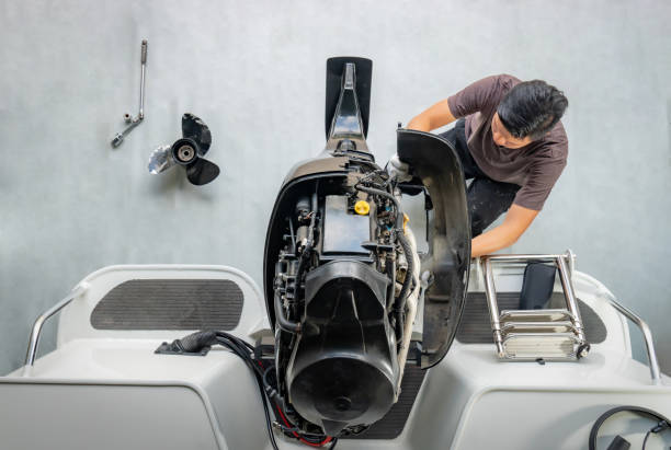 Aluminum boat repairman, for fishing Repairing engines on aluminum boats , The technician is removing the boat parts to make the paint leisure boating stock pictures, royalty-free photos & images