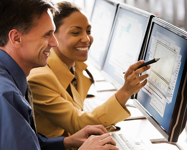 istock Businessman and Woman Looking at Computer Montitor 115556953