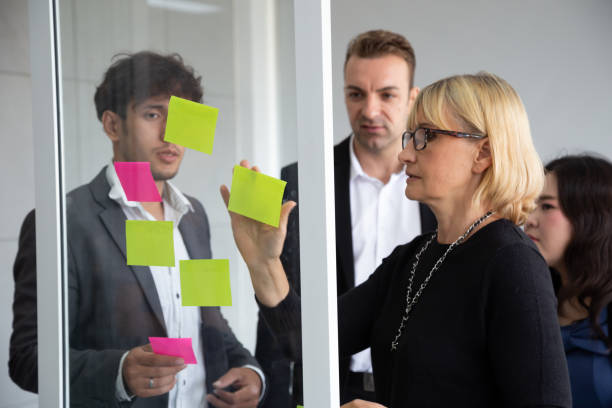 istock Business people meeting team, briefing and discussing new plan. Analyzing with teamwork on project in office and use sticky notes to share idea. Brainstorming and conference corporate concept 1155571893