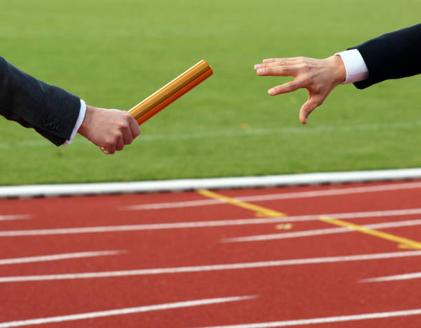 Businessman passing golden baton in relay race Concept Business Cooperation Succession Teamwork passing sport stock pictures, royalty-free photos & images