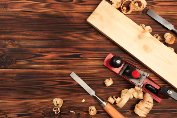 istock chisels plane and sawdust on a wooden table - Image 1155578421