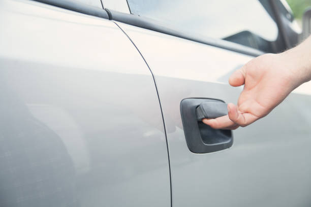 istock Hand on handle. Man hand opening a car door 1155579894