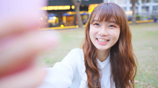 istock Young Woman Smile Take Selfie 1155580120