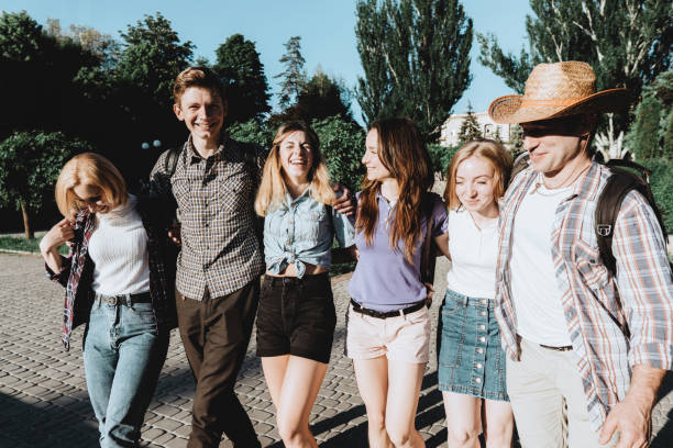 istock friends students hugging walking in the city 1155580237