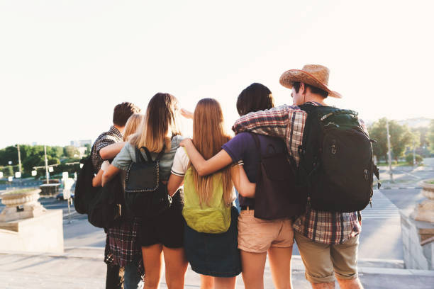 istock friends with backpacks on city background 1155580253