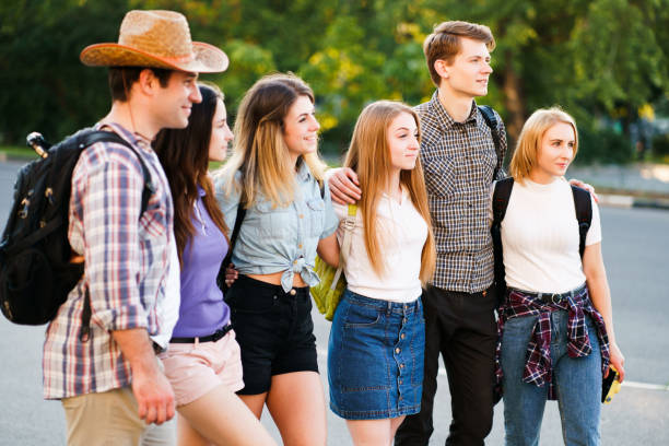 istock friends students hugging walking in the city 1155580273