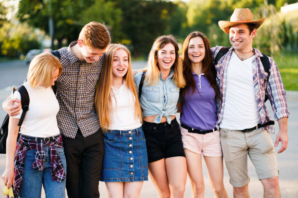 istock friends students hugging walking in the city 1155580275