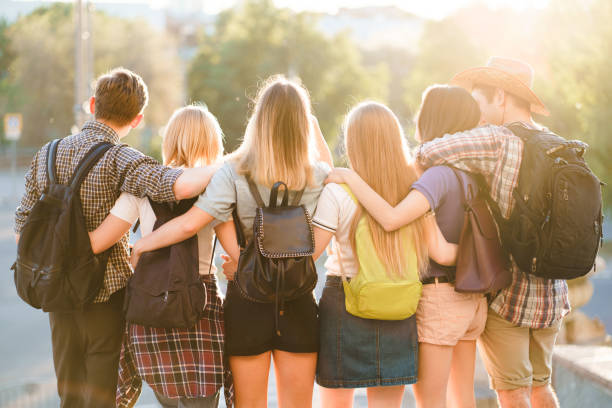 istock friends with backpacks hugging walking in the city 1155580277