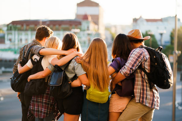 istock Happy young people hugging looking at city view 1155580278