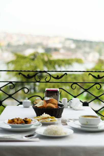 istock Dinner outside, food in plates on a balcony table 1155581736