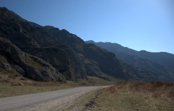 istock Asphalt road loop between the mountains goes beyond the horizon. 1155583337