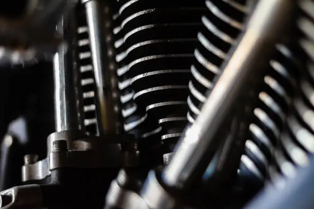 Closeup shot of a well ridden v-twin american made  motorcycle engine.  the dirt, wear and various tool and road marks shows a machine well used and loved by it's owner.