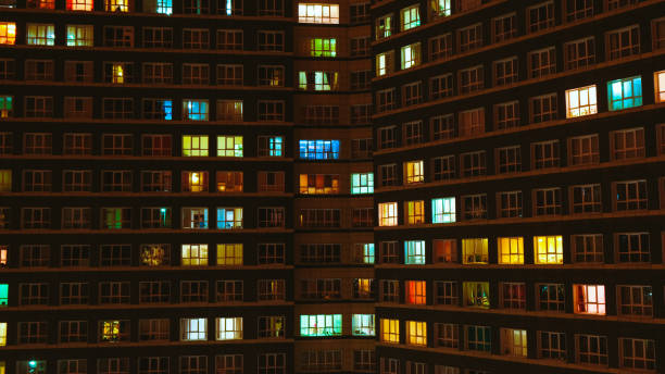 istock Light in the windows of a multistory building. Time lapse 1155585612