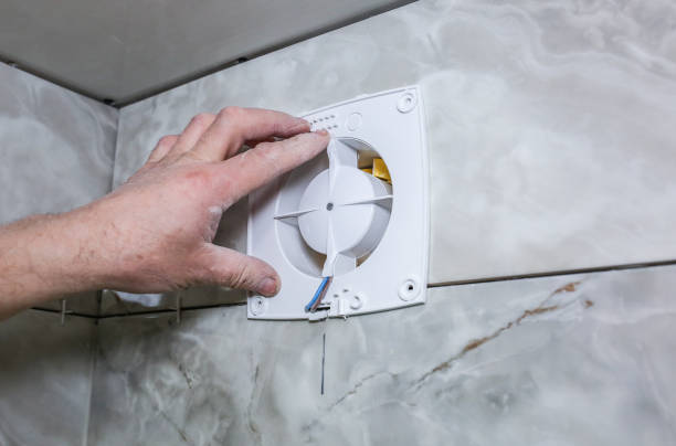 istock Man is installing the wall bathroom fan vent. Restoration process. 1155590870