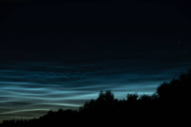 istock Noctilucent clouds or night shining clouds in the dark night sky 1155590940