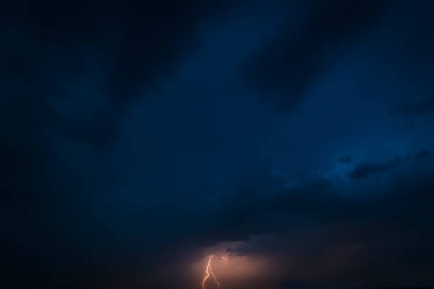 istock Lightning in the dark night sky during a summer thunderstorm 1155591094