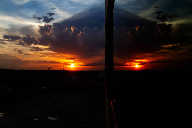 Cloud and sunset with reflection on the mirror of window