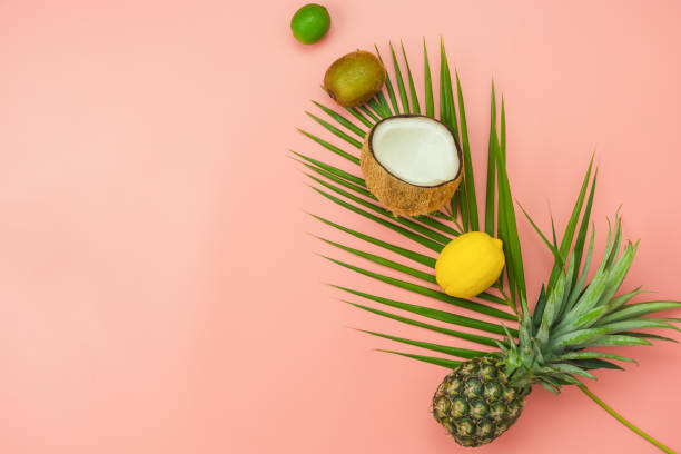 istock Table top view fruit tropical with spring summer holiday & vacation  background concept.Arrangement sliced various pineapple mango lemon and lime on palm green leaves.Items on pink paper.pastel tone. 1155591859