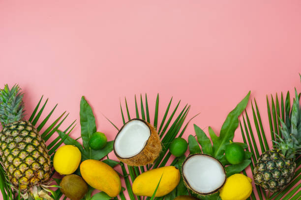 istock Table top view fruit tropical with spring summer holiday & vacation  background concept.Arrangement sliced various pineapple mango lemon and lime on monstera green leaves.Items on pink paper.pastel. 1155591860