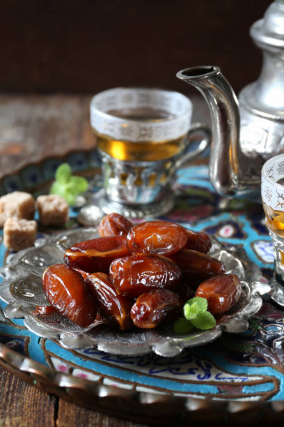 istock Ripe dates, teapot and green tea 1155593741