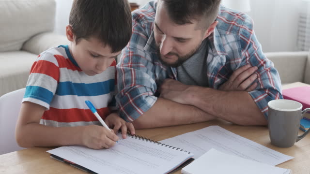 Father with son studying at home