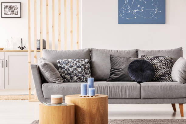 istock Pillows on grey comfortable couch in stylish living room interior 1155604595
